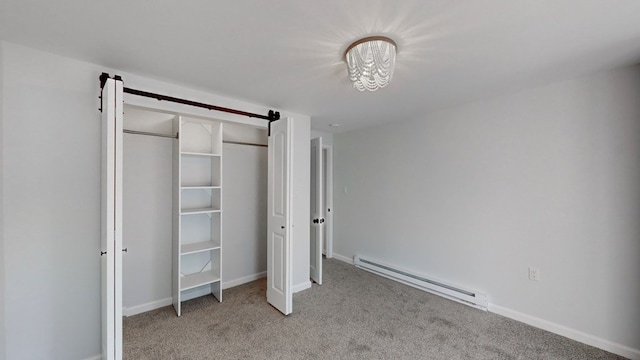 unfurnished bedroom featuring a baseboard radiator, light colored carpet, and a closet