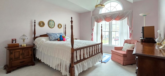 carpeted bedroom featuring lofted ceiling