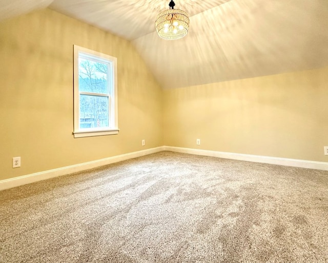 bonus room with lofted ceiling, a notable chandelier, and carpet flooring