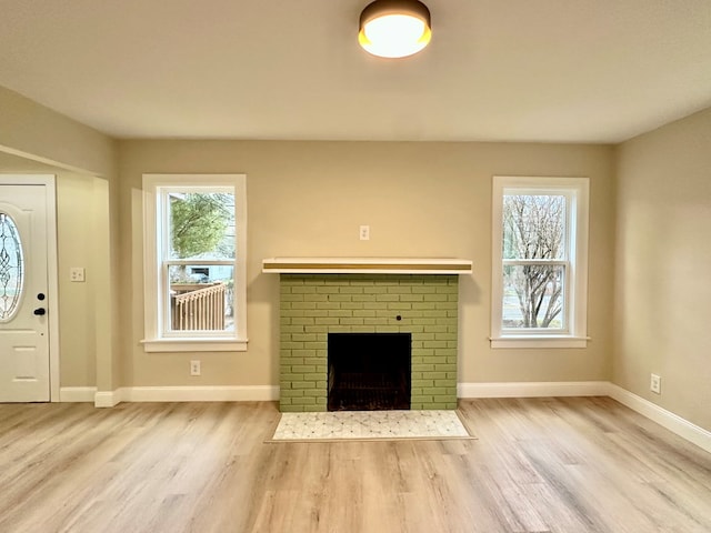 unfurnished living room featuring a fireplace and light wood-type flooring