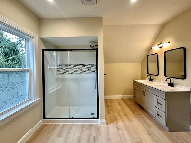 bathroom with hardwood / wood-style flooring, lofted ceiling, and an enclosed shower