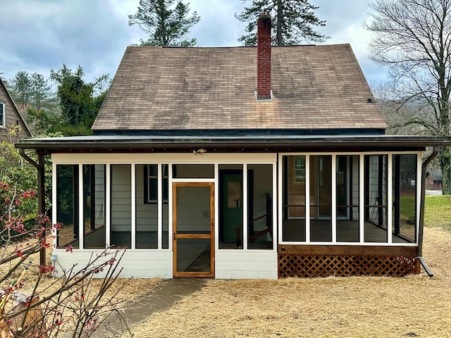 back of house featuring a sunroom