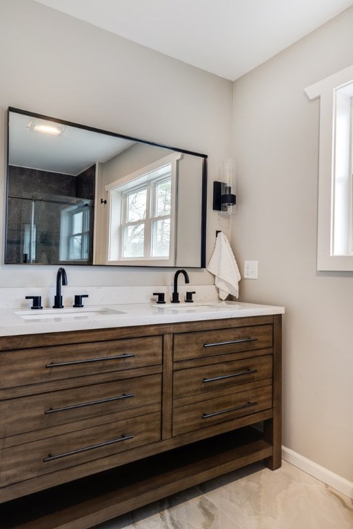 bathroom featuring vanity and a shower with door