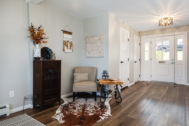 entryway featuring an inviting chandelier, dark wood-type flooring, and baseboard heating