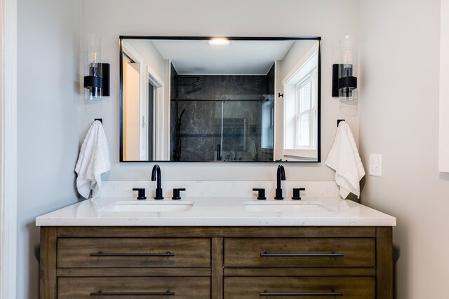 bathroom with vanity and a shower with door