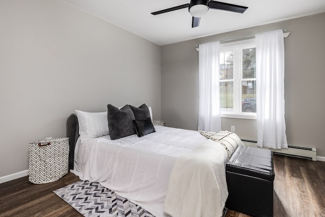 bedroom featuring a baseboard heating unit, dark wood-type flooring, and ceiling fan