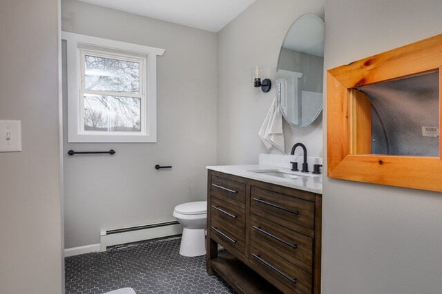 bathroom featuring a baseboard radiator, vanity, and toilet