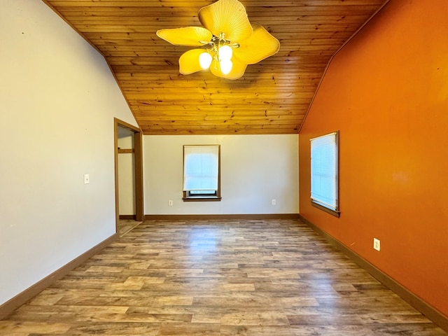 spare room with wood ceiling, ceiling fan, wood-type flooring, and high vaulted ceiling