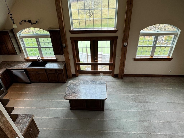 entrance foyer featuring a towering ceiling, sink, and french doors