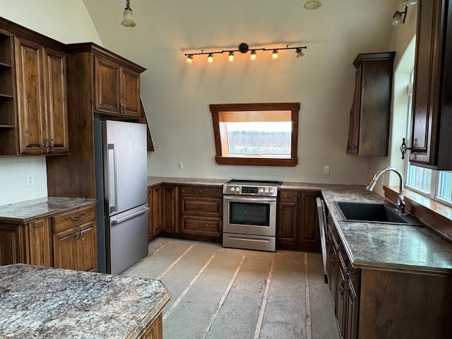 kitchen featuring appliances with stainless steel finishes, sink, and dark brown cabinets