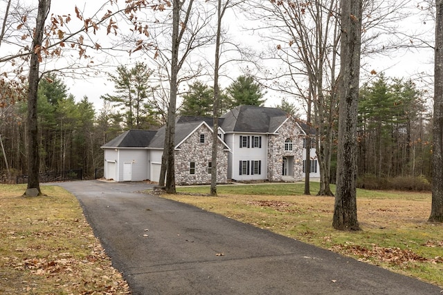 view of front of house featuring a garage and a front lawn