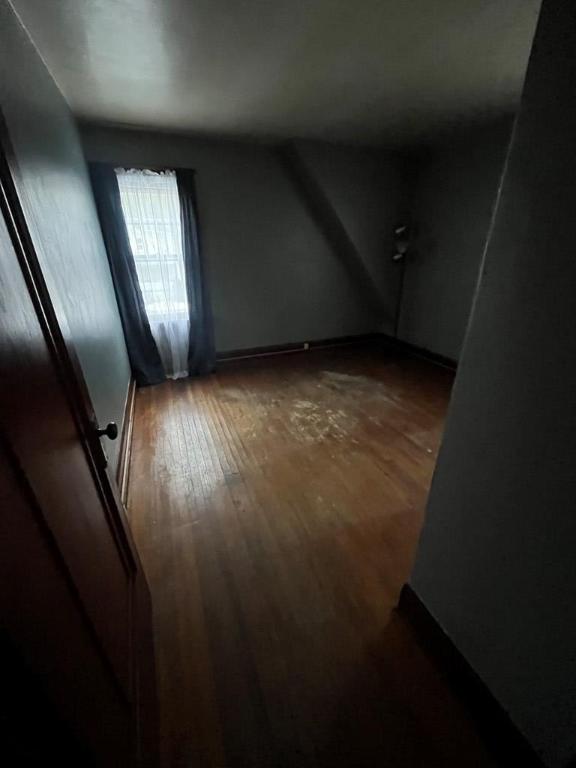 bonus room with dark wood-type flooring