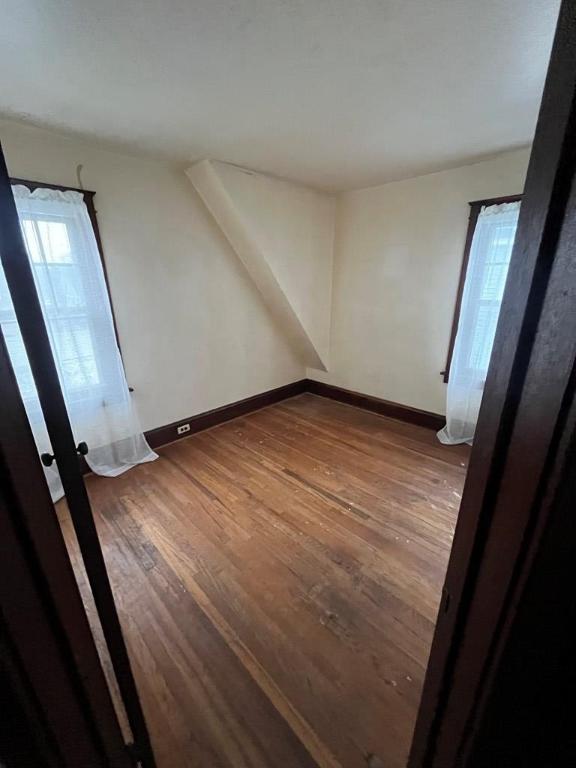 spare room with hardwood / wood-style floors