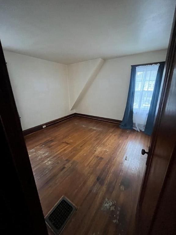 additional living space featuring dark hardwood / wood-style floors