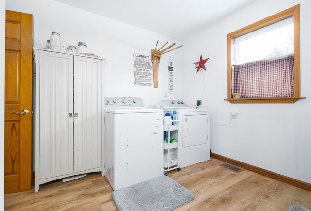 washroom with light hardwood / wood-style flooring and independent washer and dryer