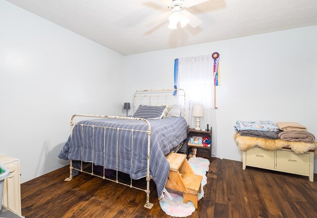 bedroom featuring dark hardwood / wood-style floors and ceiling fan