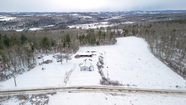 snowy aerial view with a mountain view