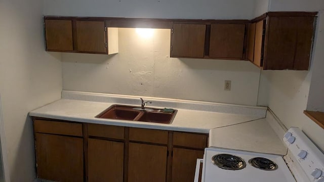 kitchen featuring sink and electric range