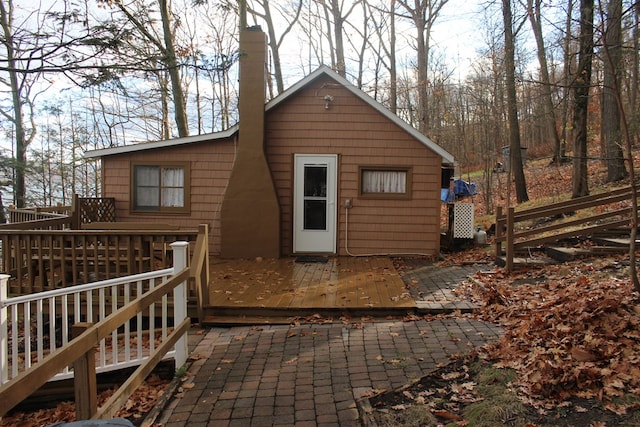 back of house with a deck and a patio area