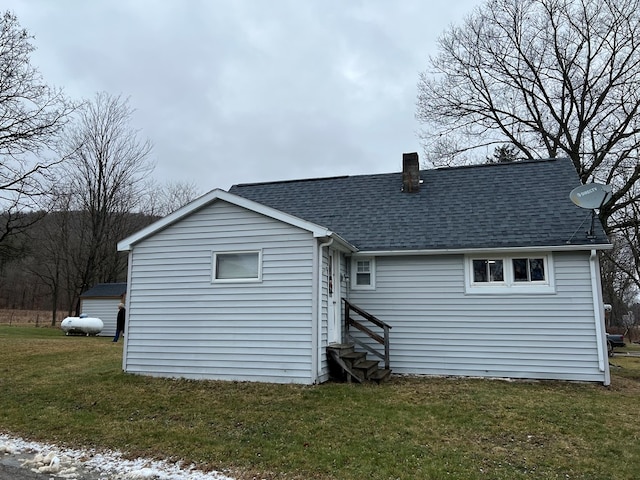 rear view of property with a lawn