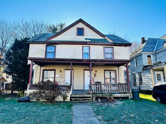 view of front of home with a front lawn and a porch