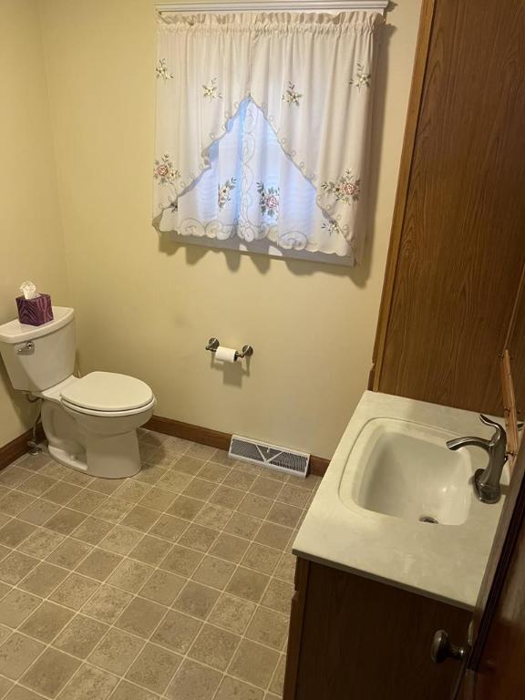 bathroom with vanity, toilet, and tile patterned flooring