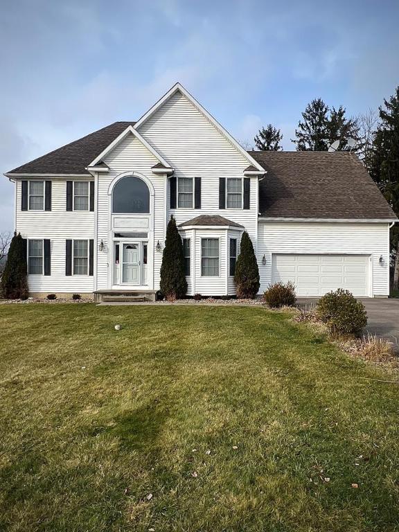 view of front of house with a garage and a front lawn