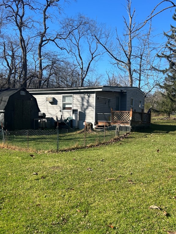 view of front facade with a wooden deck and a front yard