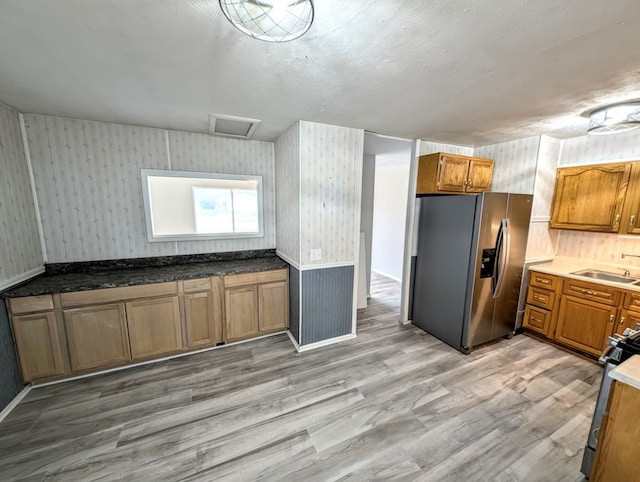 kitchen featuring sink, stainless steel appliances, and light hardwood / wood-style floors