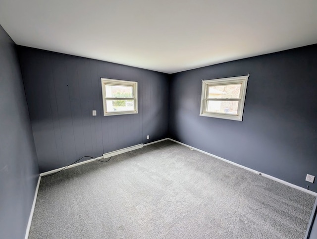 carpeted empty room featuring a healthy amount of sunlight