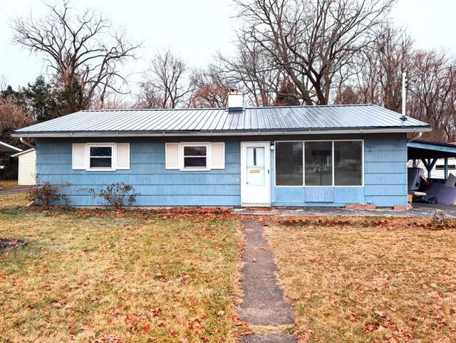 single story home featuring a carport and a front yard