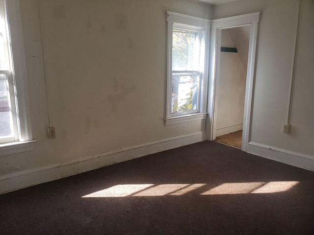 empty room featuring dark colored carpet