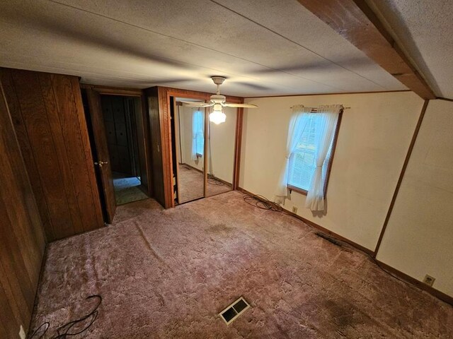 unfurnished bedroom featuring ceiling fan and carpet flooring