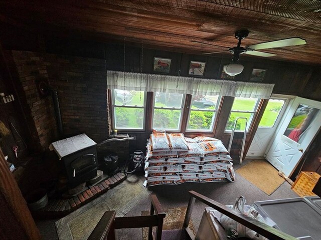 bedroom with wooden ceiling, ceiling fan, and wood walls