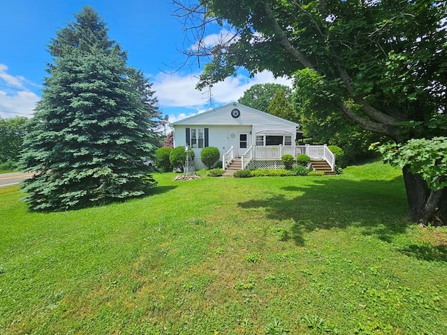 view of front of home featuring a deck and a front yard