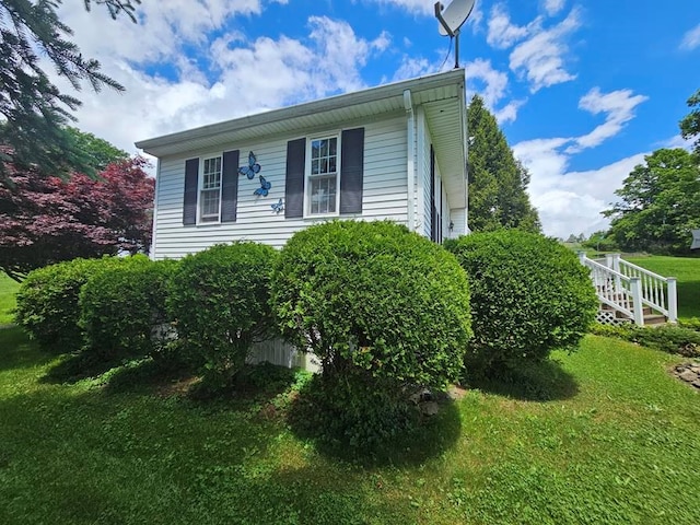 view of side of home with a lawn