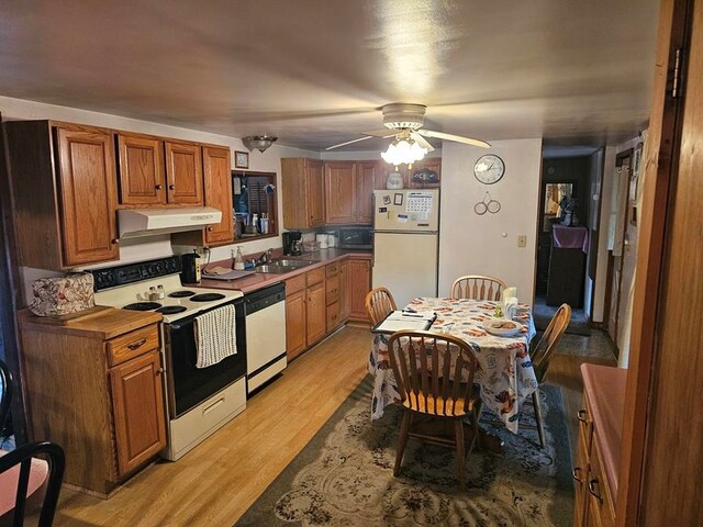 kitchen featuring ceiling fan, sink, white appliances, and light hardwood / wood-style floors