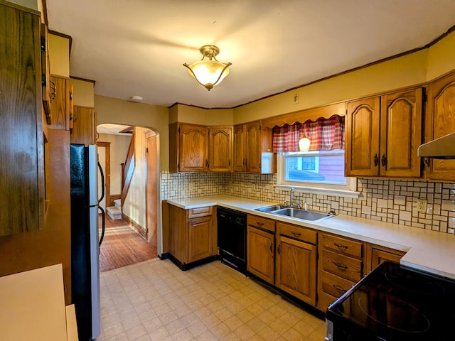 kitchen featuring sink, tasteful backsplash, stainless steel fridge, dishwasher, and stove