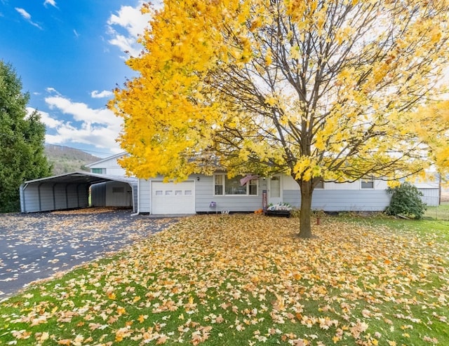 obstructed view of property with a carport and a garage