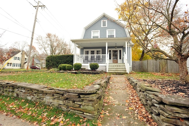 view of front of property with a front yard and covered porch