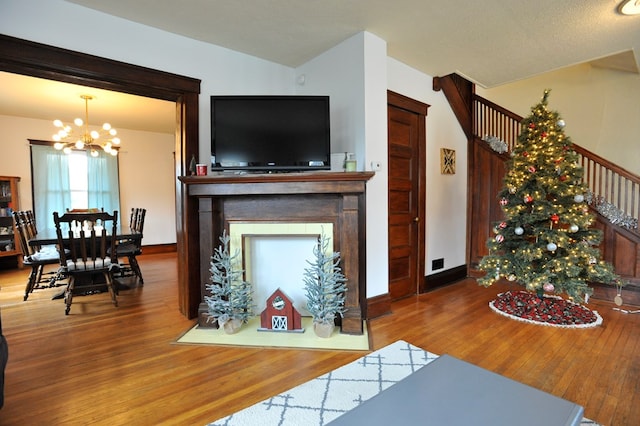 living room featuring an inviting chandelier and hardwood / wood-style floors