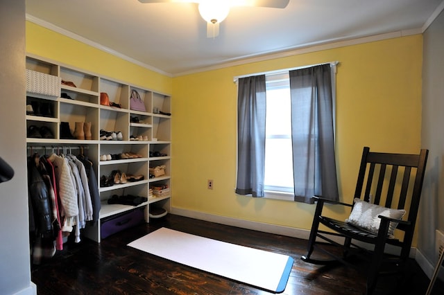 sitting room featuring dark wood-type flooring, ceiling fan, and ornamental molding