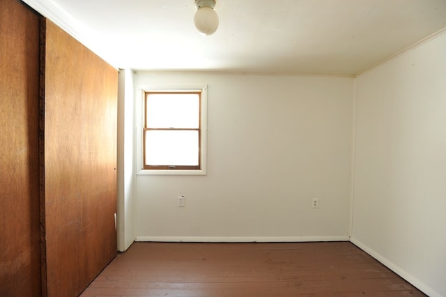 empty room with hardwood / wood-style flooring