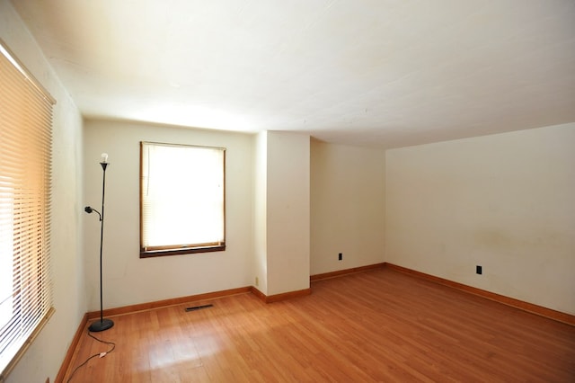 unfurnished room with light hardwood / wood-style floors