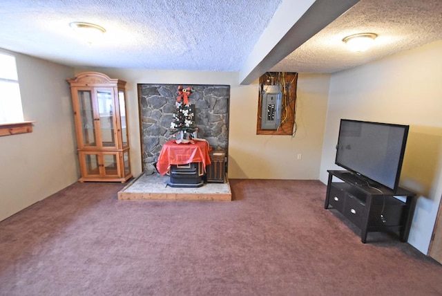 rec room featuring a wood stove, dark colored carpet, electric panel, plenty of natural light, and a textured ceiling