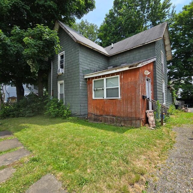 view of property exterior with a yard