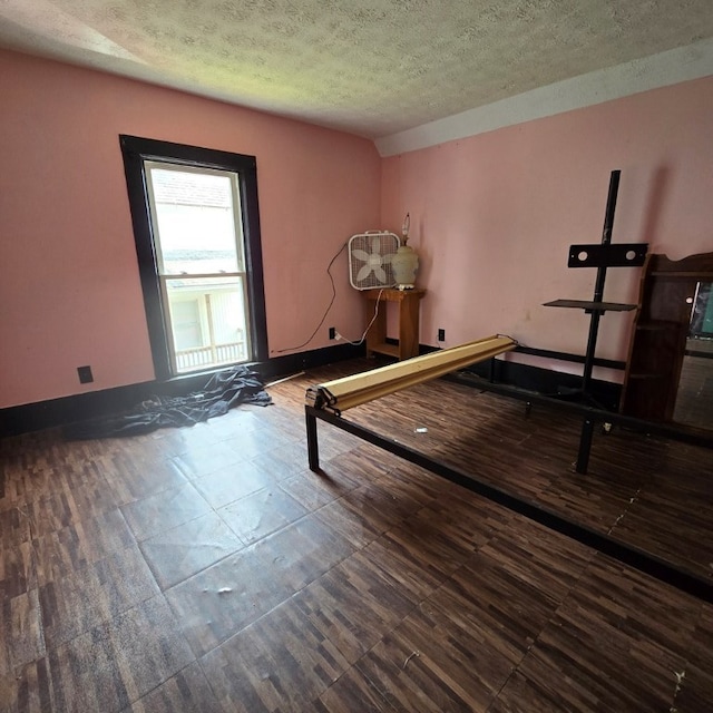 exercise room featuring a textured ceiling