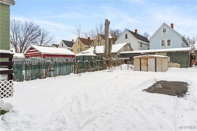 snowy yard with a shed