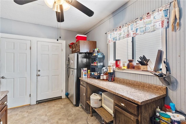 kitchen with dark brown cabinetry, stainless steel fridge, and ceiling fan