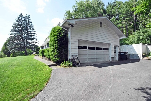 garage featuring a lawn